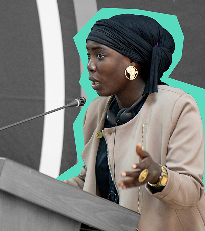 A young, elegant woman speaking with a microphone 