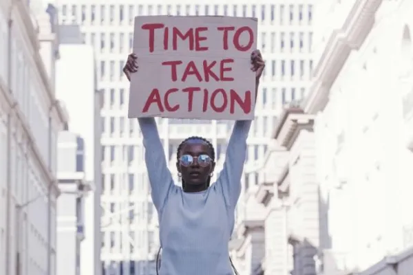 Young woman with poster Time to Take Action