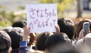 A supporter holds a sign reading “Go Sana-chan!” at a street rally for Prime Minister Sanae Takaichi in Fukuoka, Japan on Jan. 30. © Kyodo