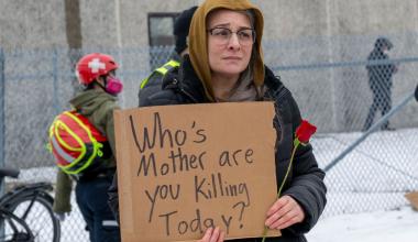 A protester holds a sign in front of the Whipple Federal building in response to an ICE agent’s killing Renee Good.(Michael Siluk / Universal Images Group via Getty Images)