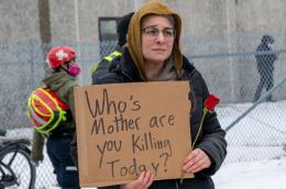 A protester holds a sign in front of the Whipple Federal building in response to an ICE agent’s killing Renee Good.(Michael Siluk / Universal Images Group via Getty Images)