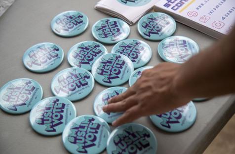 Atlanta, Georgia — My Muslim Voter pins are displayed at the Georgia Muslim Voter Project table outside of the Al-Farooq Masjid in downtown Atlanta, Friday, August 27, 2021. (Alyssa Pointer/Atlanta Journal Constitution) - Wisconsin Muslim Journal