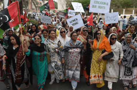 Women political activists hold placards as they march during a rally to mark International Women’s Day in Karachi, Pakistan. 