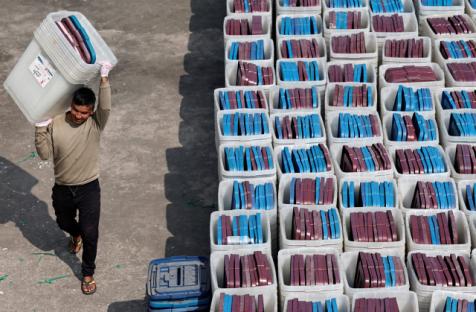 A security personnel carries ballot boxes toward a vehicle sending them to different constituency from the election commission ahead of the general election in Kathmandu, Nepal, February 8, 2026. Navesh Chitraker/Reuters