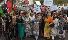 Women political activists hold placards as they march during a rally to mark International Women’s Day in Karachi, Pakistan. 